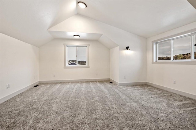 bonus room with carpet flooring and lofted ceiling