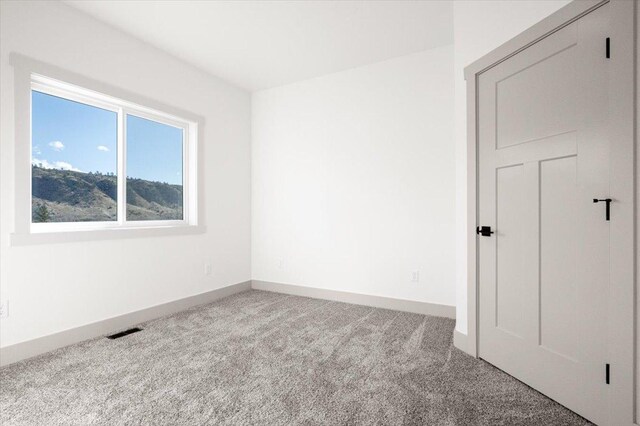 5539 Fireweed Loop, Helena, MT 59602 - living area featuring visible vents, carpet floors, baseboards, and vaulted ceiling