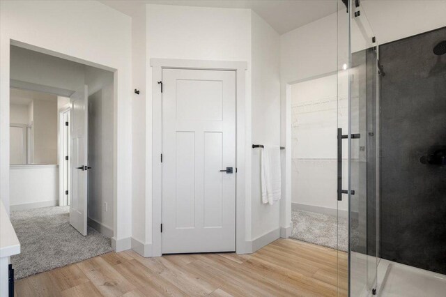 5539 Fireweed Loop, Helena, MT 59602 - full bathroom with washtub / shower combination, toilet, vanity, and wood finished floors