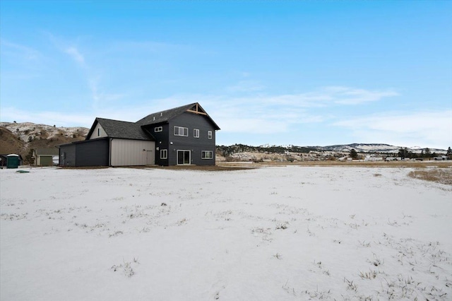 snow covered property with a mountain view