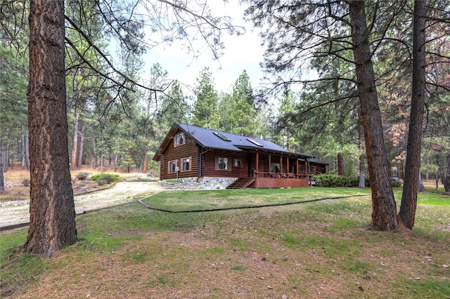 log-style house featuring a front lawn