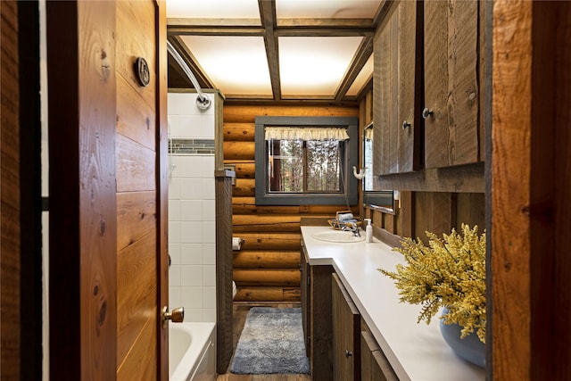 bathroom with beamed ceiling, oversized vanity, log walls, and  shower combination