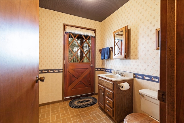 bathroom featuring large vanity and toilet