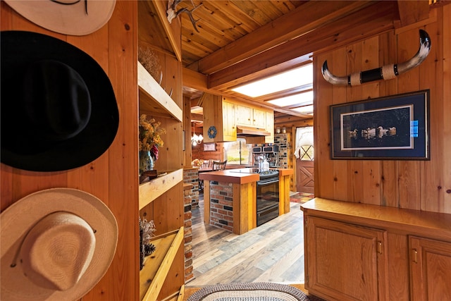 interior space with light hardwood / wood-style floors and wood walls