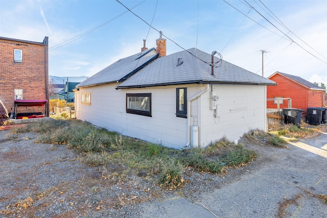 735 Placer St, Butte, MT 59701 - view of side of property featuring a chimney and a garage