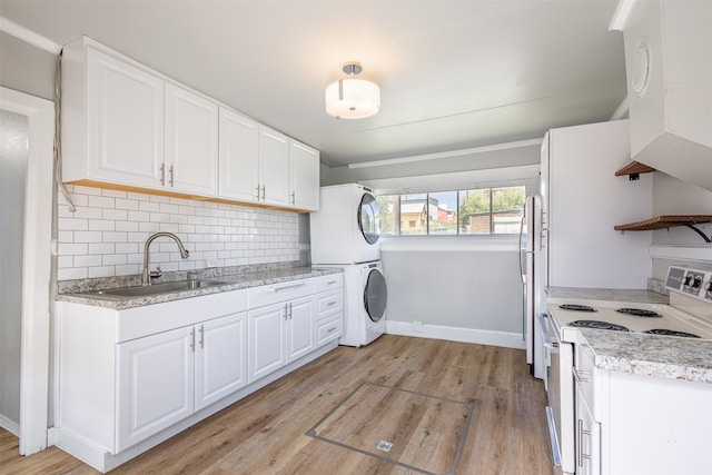 washroom featuring light hardwood / wood-style flooring, stacked washer and clothes dryer, and sink