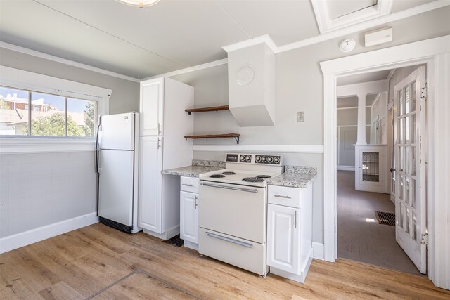 kitchen with light hardwood / wood-style floors, ornamental molding, white cabinetry, and white appliances