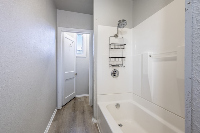 bathroom with tub / shower combination and hardwood / wood-style floors