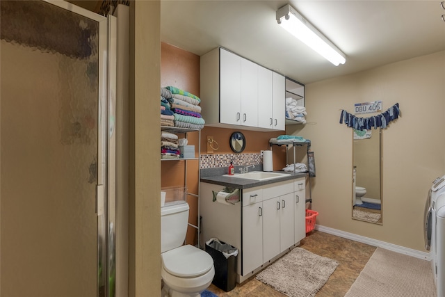 bathroom featuring tile flooring, vanity, an enclosed shower, and toilet