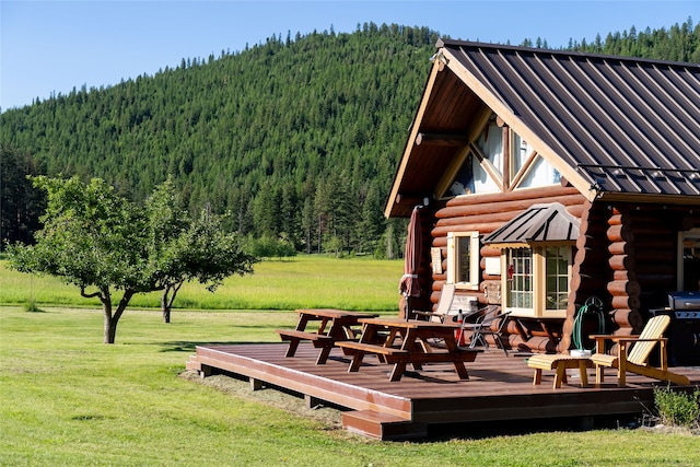 exterior space featuring a deck and a lawn