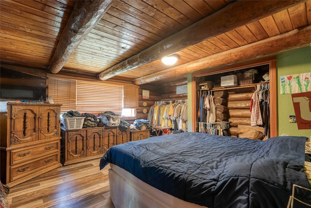 bedroom featuring a closet, beamed ceiling, dark hardwood / wood-style flooring, log walls, and wood ceiling