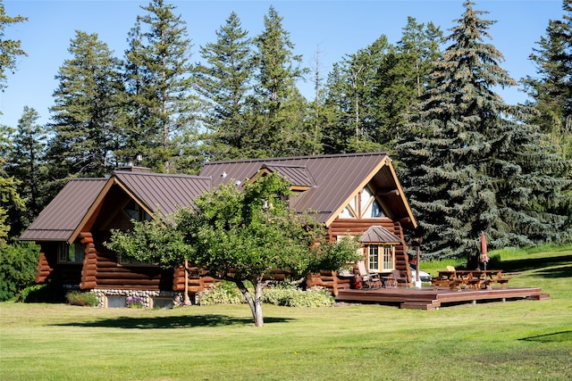 exterior space with a wooden deck and a front yard