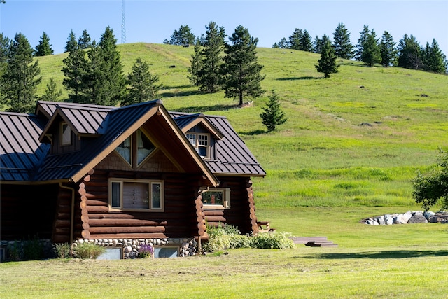 log-style house with a rural view and a front lawn