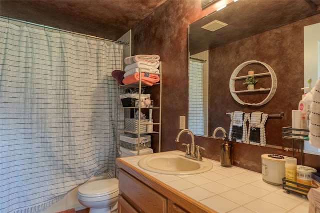 bathroom with large vanity and toilet