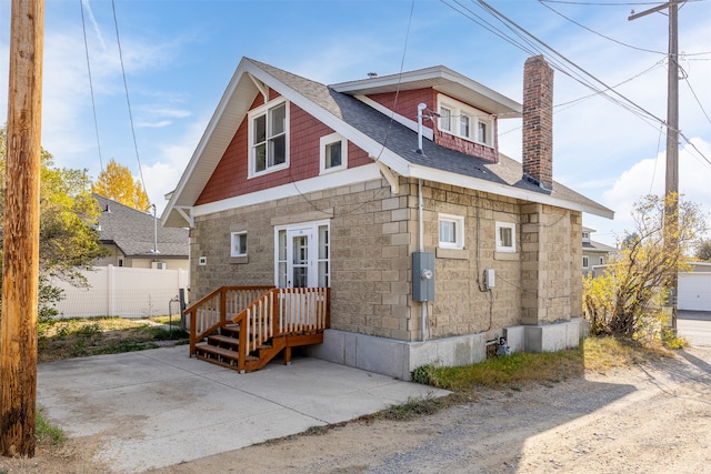 back of property with a garage