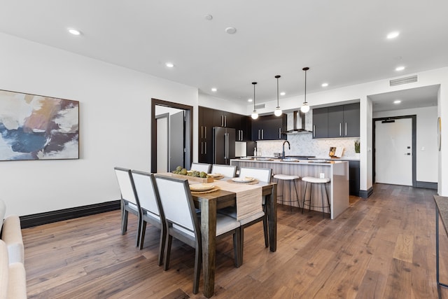 dining space featuring dark hardwood / wood-style floors and sink