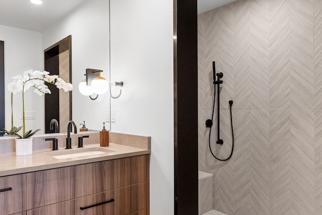 bathroom featuring a shower and vanity