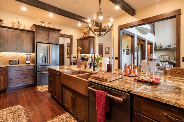 kitchen featuring beamed ceiling, dark wood-type flooring, dark brown cabinets, stainless steel appliances, and a notable chandelier