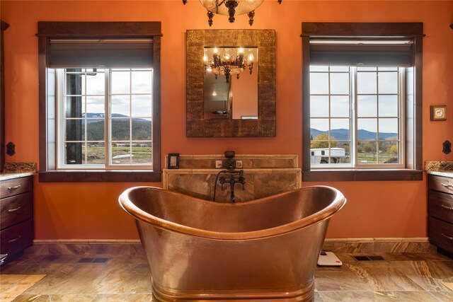 dining room featuring a mountain view, tile floors, and a chandelier