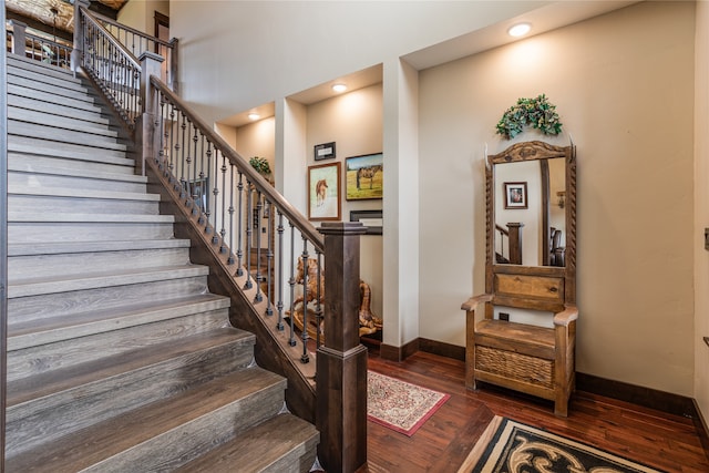 stairs featuring dark hardwood / wood-style flooring