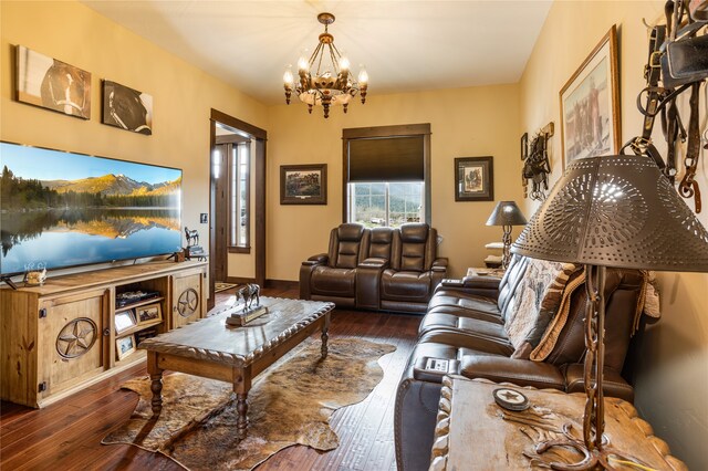 living room featuring an inviting chandelier and dark hardwood / wood-style flooring