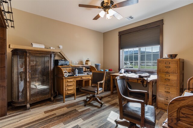 home office featuring wood-type flooring and ceiling fan