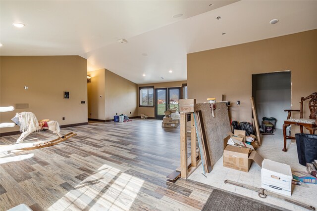 interior space featuring hardwood / wood-style flooring and vaulted ceiling