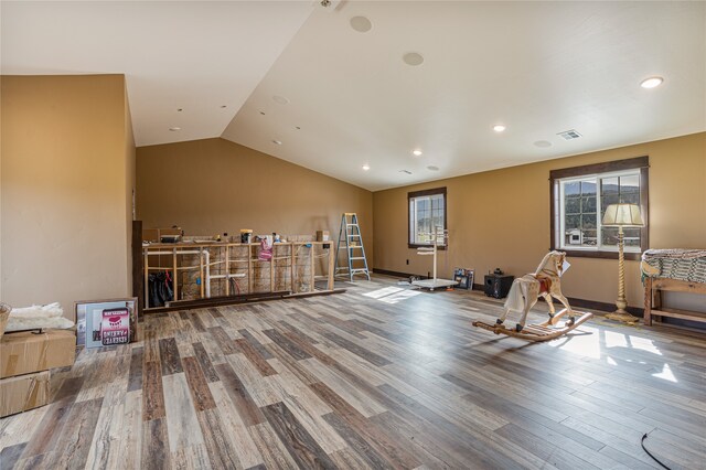 workout room with lofted ceiling and hardwood / wood-style flooring