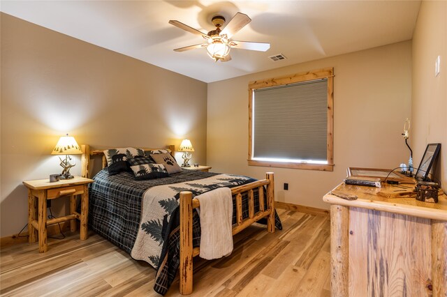 bedroom with ceiling fan and light hardwood / wood-style floors