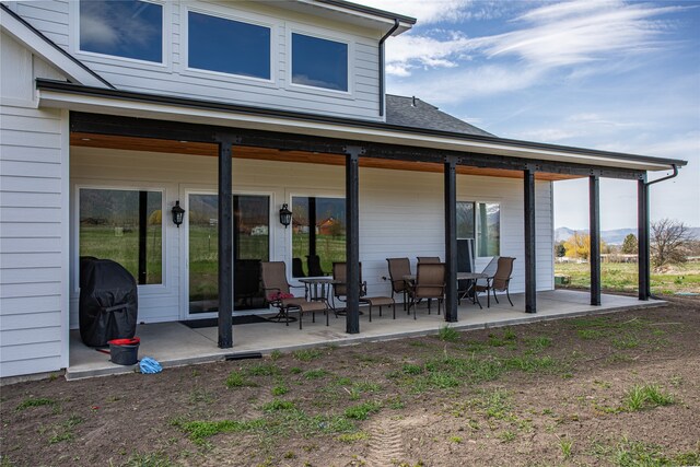 rear view of property featuring a patio area