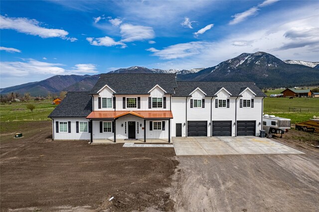 view of front facade with a mountain view and a garage