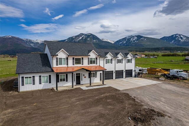 view of front of house with a garage and a mountain view