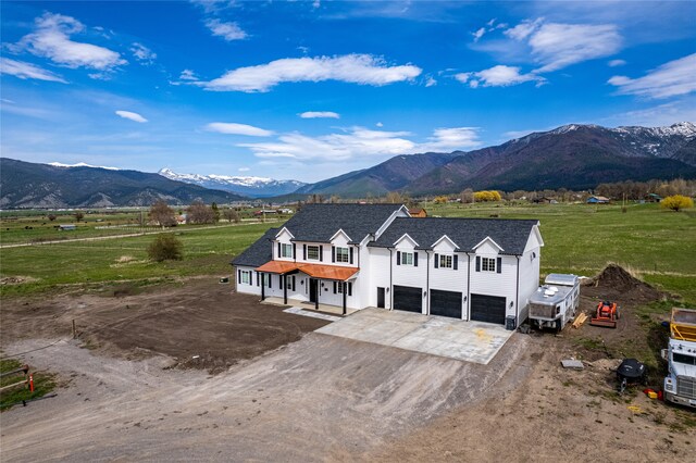 view of front of property with a mountain view and a garage