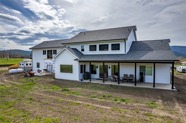 back of property featuring a patio and a mountain view