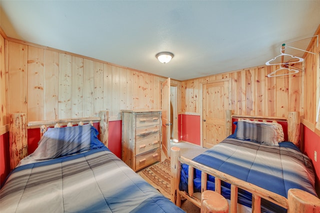 bedroom featuring wood walls