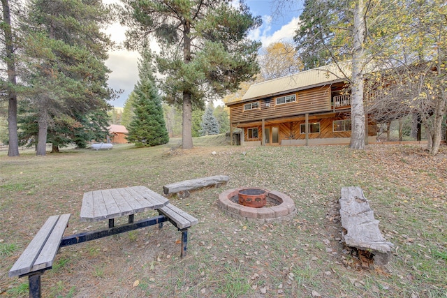 view of yard with a deck and a fire pit