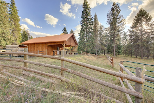 view of horse barn with a rural view and an outdoor structure