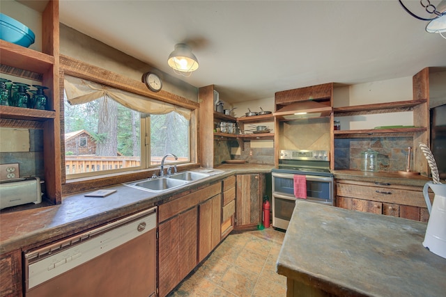 kitchen featuring light tile floors, double oven range, sink, dishwasher, and wall chimney range hood