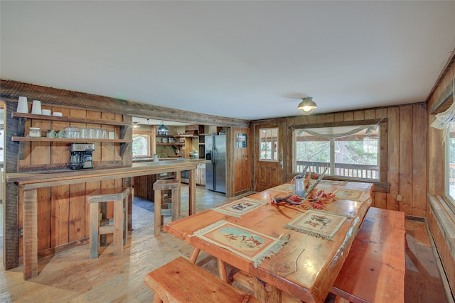 dining area featuring wooden walls