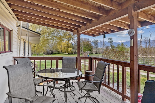 wooden terrace with a lawn