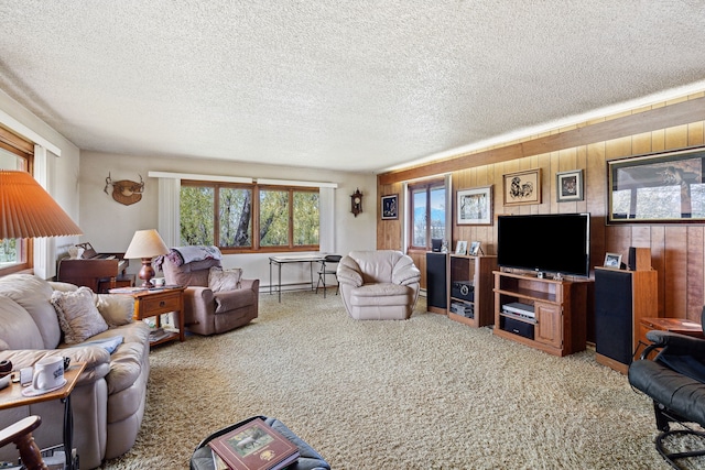 carpeted living room with wood walls and a textured ceiling