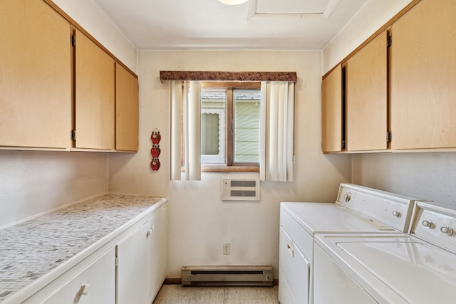 laundry area featuring cabinets, baseboard heating, and washer and clothes dryer