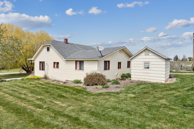 rear view of property with a lawn