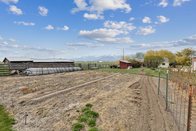 view of yard with a rural view and an outdoor structure