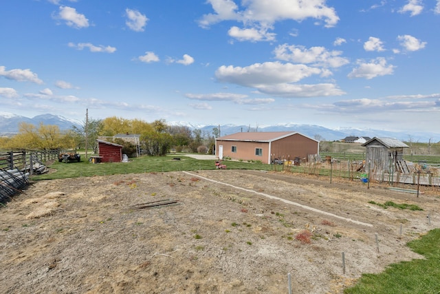 view of yard featuring a playground, a mountain view, and a rural view