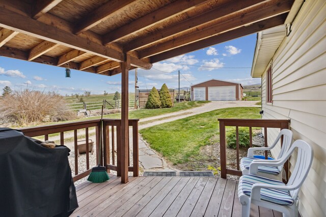 1848 Mountain View Orchard Rd, Corvallis, MT 59828 - deck featuring a grill, a detached garage, a yard, and an outbuilding