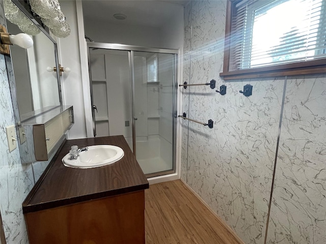 bathroom featuring hardwood / wood-style floors, vanity, and walk in shower