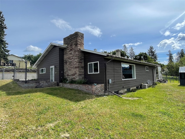 view of side of property with a yard and central AC unit