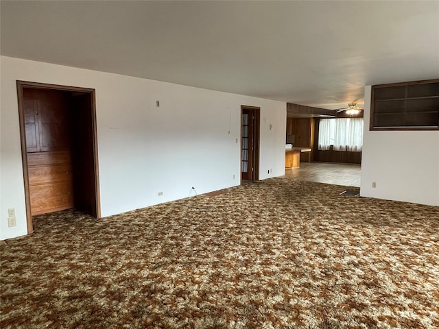 empty room with carpet flooring and ceiling fan