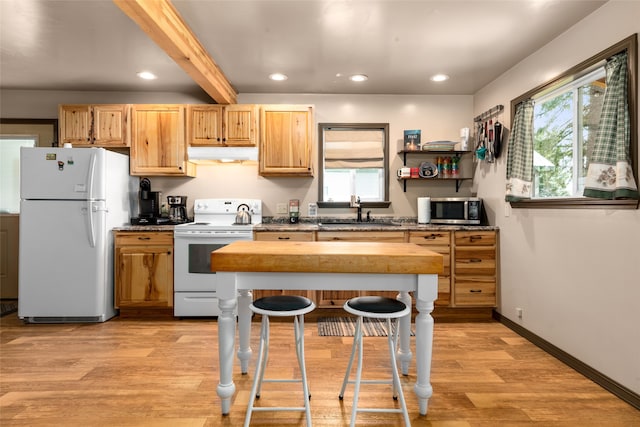 kitchen with sink, light hardwood / wood-style flooring, beamed ceiling, white appliances, and a healthy amount of sunlight